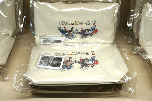 Merchandise display at the Yuru Camp 10th Anniversary Exhibition shop.