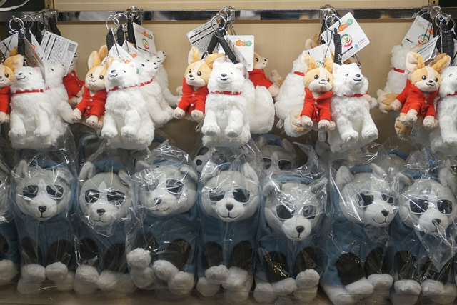 Selection of exclusive Yuru Camp merchandise, including plushies.
